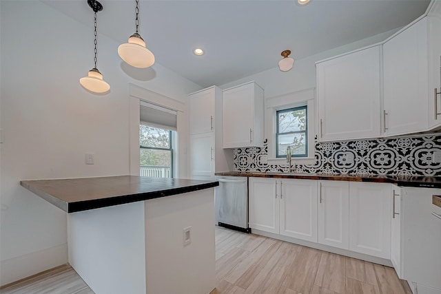 kitchen featuring white cabinetry, sink, and dishwasher