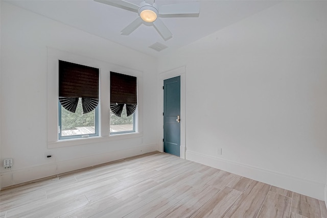 spare room with light hardwood / wood-style flooring and ceiling fan