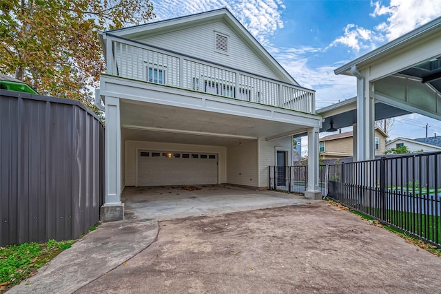 view of front of house featuring a garage and a balcony