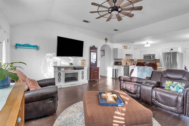 living room with lofted ceiling, sink, dark hardwood / wood-style floors, and ceiling fan