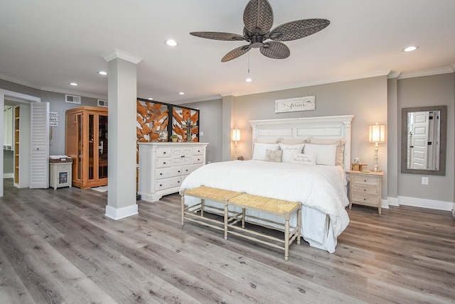 bedroom with crown molding, ceiling fan, and hardwood / wood-style flooring