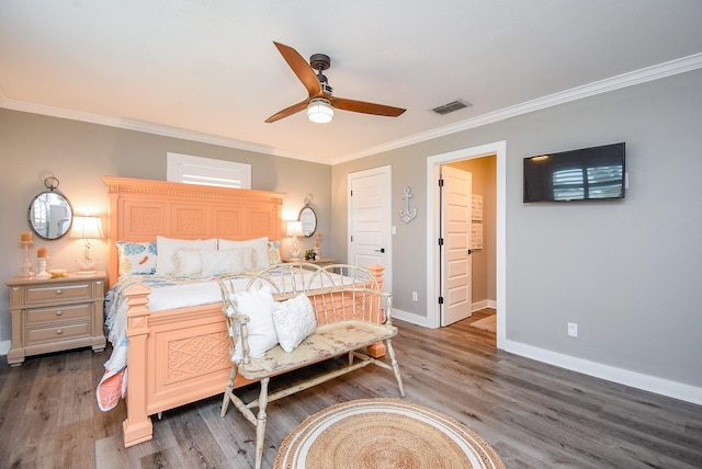 bedroom with ornamental molding, dark hardwood / wood-style floors, ceiling fan, and ensuite bath