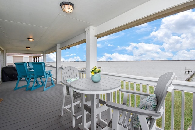 wooden terrace featuring a water view