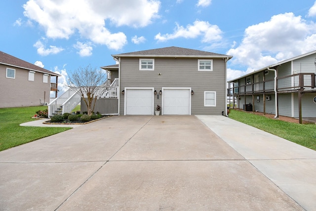 front of property with a garage, a front yard, and central air condition unit