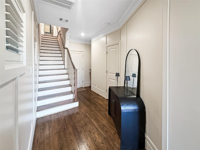 corridor with ornamental molding and dark wood-type flooring