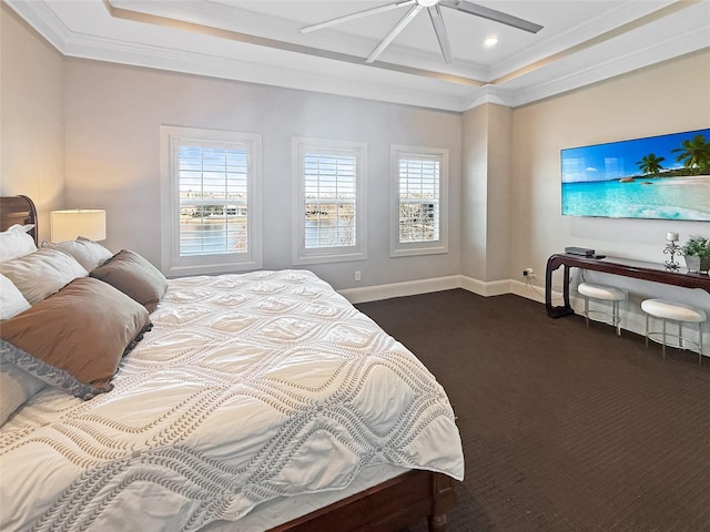 carpeted bedroom with ceiling fan, crown molding, and a tray ceiling