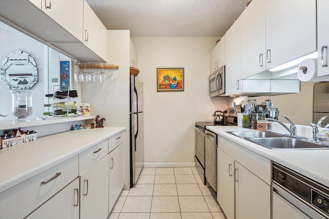 kitchen with sink, stainless steel appliances, and white cabinets