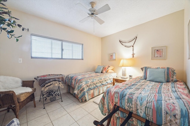 bedroom featuring light tile patterned floors, a textured ceiling, and ceiling fan