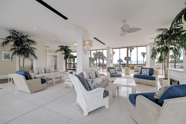 living room featuring ceiling fan and floor to ceiling windows