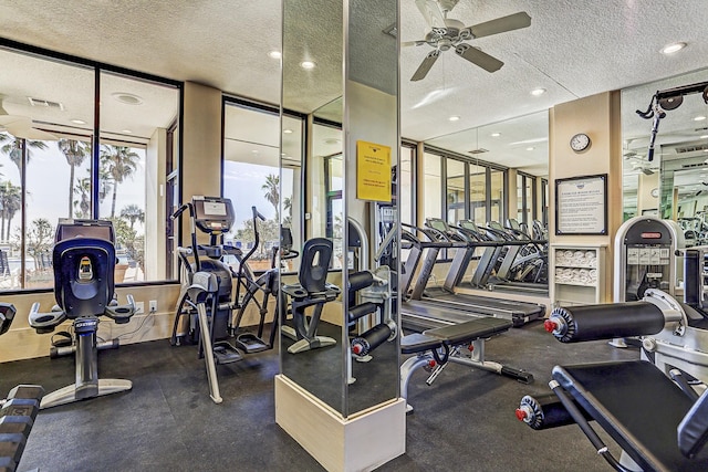 workout area featuring a ceiling fan, recessed lighting, a textured ceiling, and visible vents