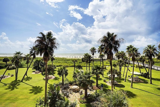 view of community featuring a water view and a yard