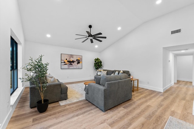 living room with ceiling fan, high vaulted ceiling, and light hardwood / wood-style floors