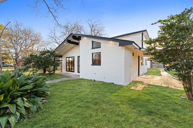 rear view of house featuring a yard