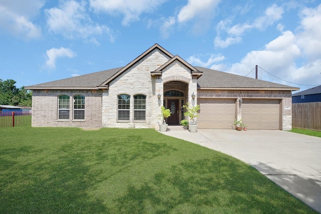 view of front of home with a garage and a front lawn