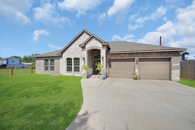 french provincial home featuring a garage and a front yard