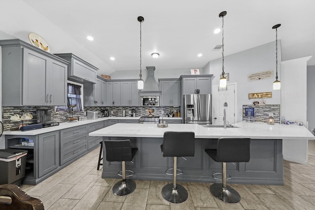 kitchen featuring hanging light fixtures, appliances with stainless steel finishes, sink, and gray cabinetry