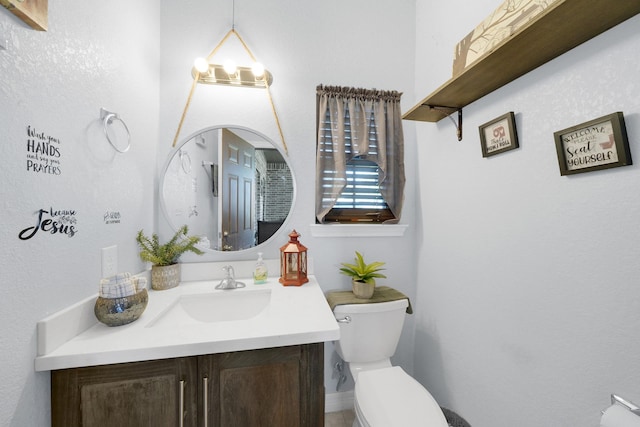 bathroom with vanity and toilet