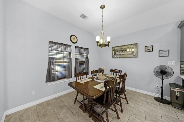 tiled dining space with an inviting chandelier and lofted ceiling