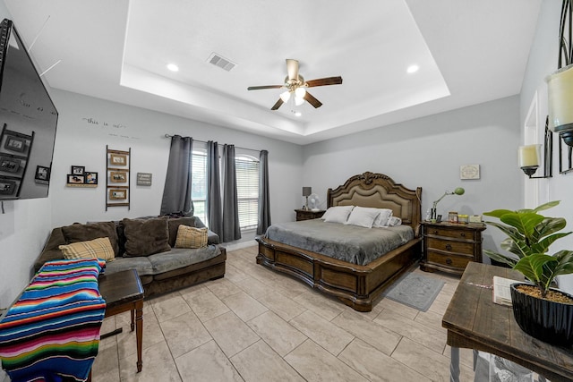 bedroom featuring ceiling fan and a tray ceiling