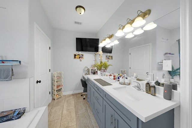 bathroom with tile patterned flooring and vanity