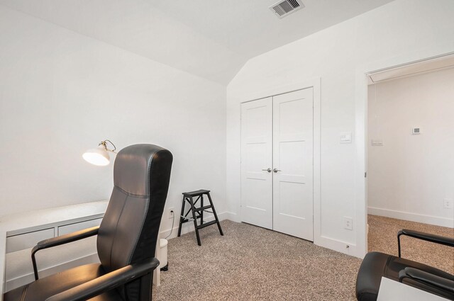 carpeted office with lofted ceiling