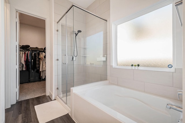 bathroom featuring hardwood / wood-style flooring and shower with separate bathtub