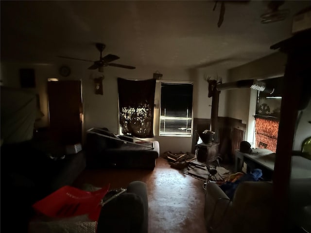 miscellaneous room with ceiling fan and a wood stove