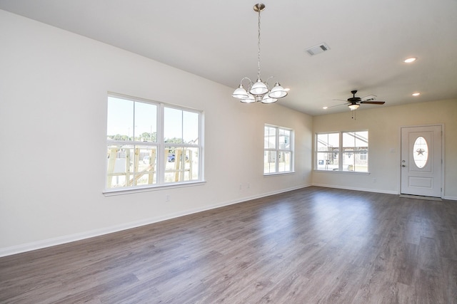 interior space featuring dark wood-type flooring and ceiling fan with notable chandelier