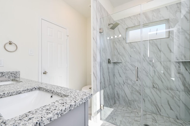 bathroom featuring vanity, an enclosed shower, and toilet