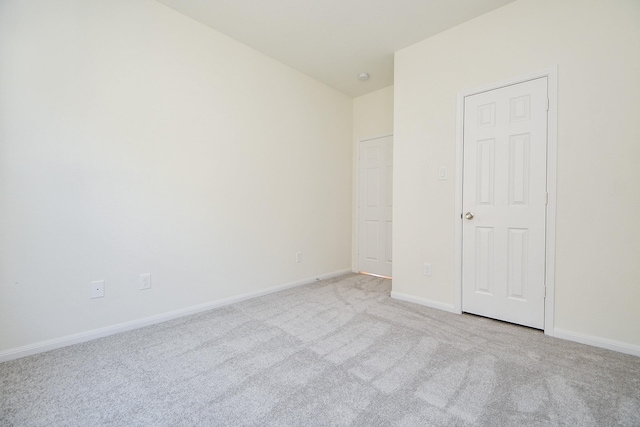 unfurnished bedroom with light colored carpet