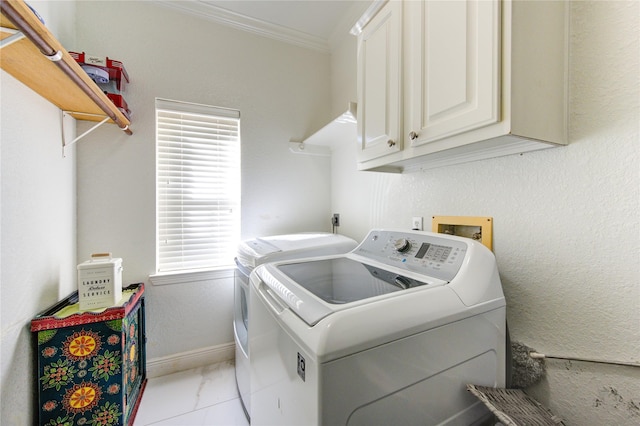 clothes washing area with cabinets, light tile patterned floors, a wealth of natural light, and independent washer and dryer