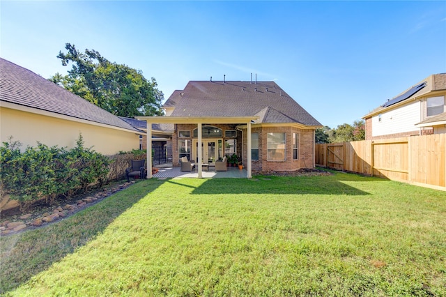 back of property featuring a yard and a patio area