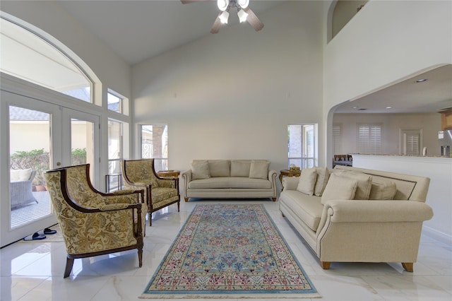 living room featuring a high ceiling and ceiling fan