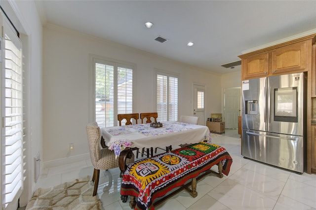 tiled dining room with ornamental molding