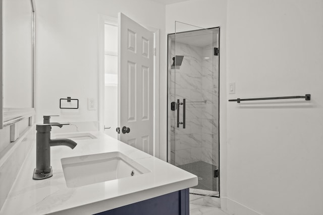 bathroom featuring a shower with door and vanity