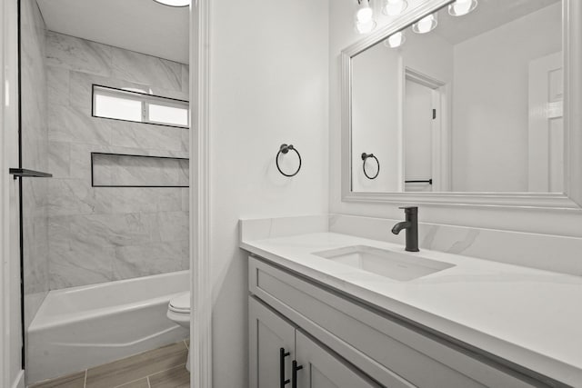 full bathroom featuring vanity, toilet, and tiled shower / bath combo