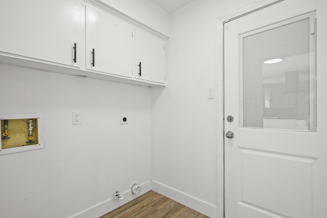 laundry room featuring gas dryer hookup, cabinets, wood-type flooring, washer hookup, and hookup for an electric dryer