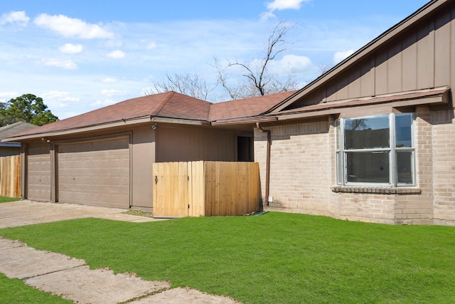 view of property exterior featuring a yard and a garage