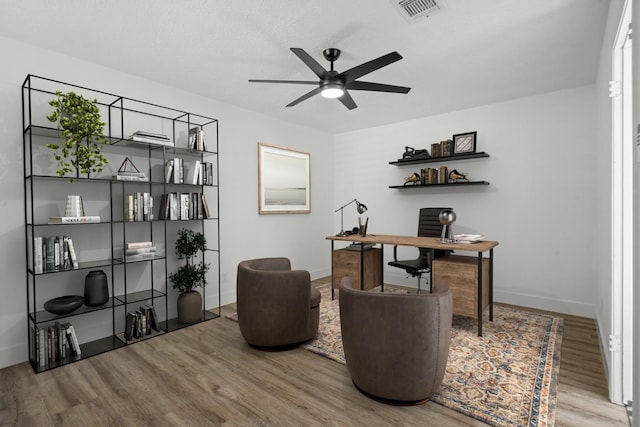 office with wood-type flooring and ceiling fan