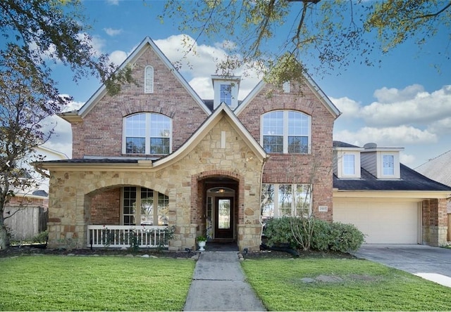 view of front of property featuring a porch, a garage, and a front lawn