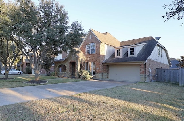 view of front of house featuring a garage and a front lawn