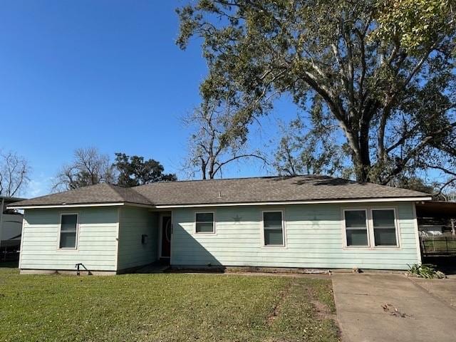 back of house with a yard and a carport