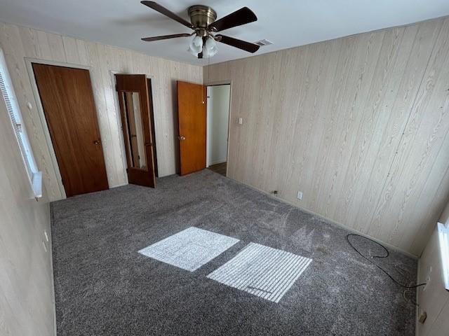 unfurnished bedroom with carpet flooring and ceiling fan