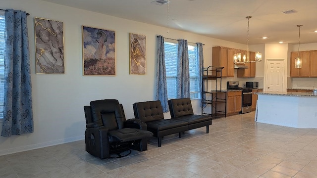 living room with light tile patterned floors and a chandelier