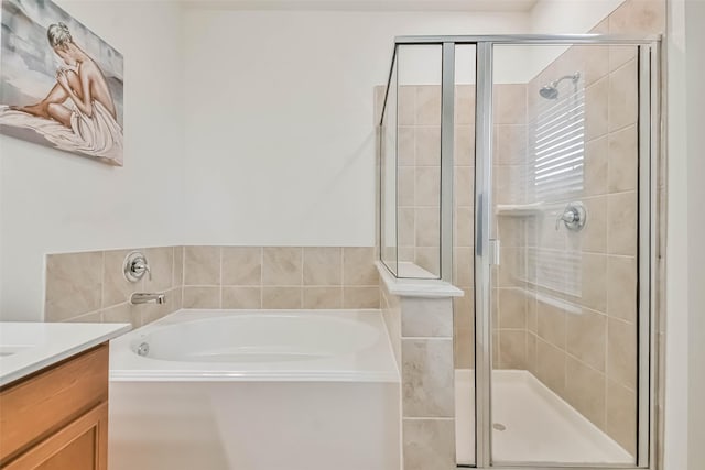 bathroom featuring vanity and shower with separate bathtub