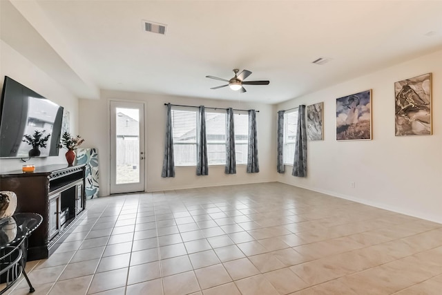 tiled living room featuring ceiling fan