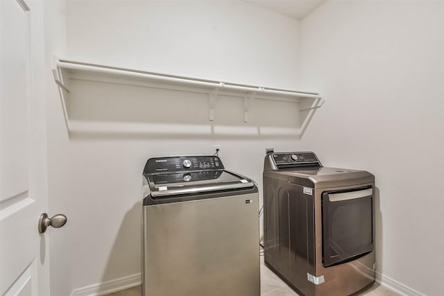 washroom featuring washer and clothes dryer