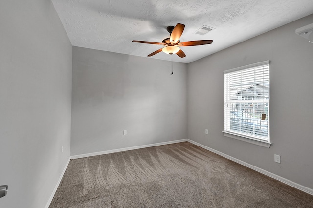 carpeted spare room with ceiling fan and a textured ceiling