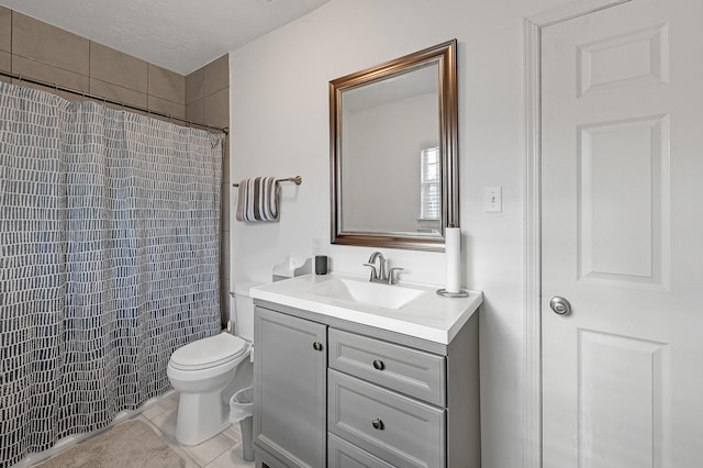 bathroom with tile patterned flooring, vanity, curtained shower, and toilet