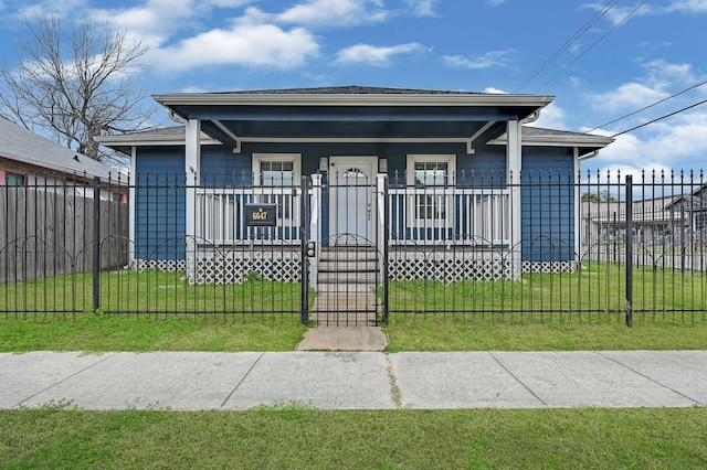 bungalow-style house featuring a front yard and covered porch